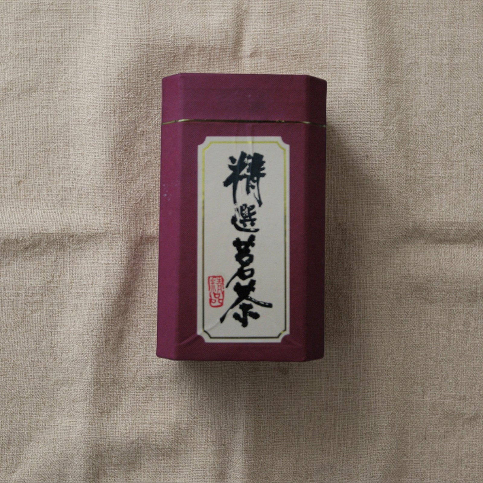 after: AI photoshoot of a tea tin with printed text