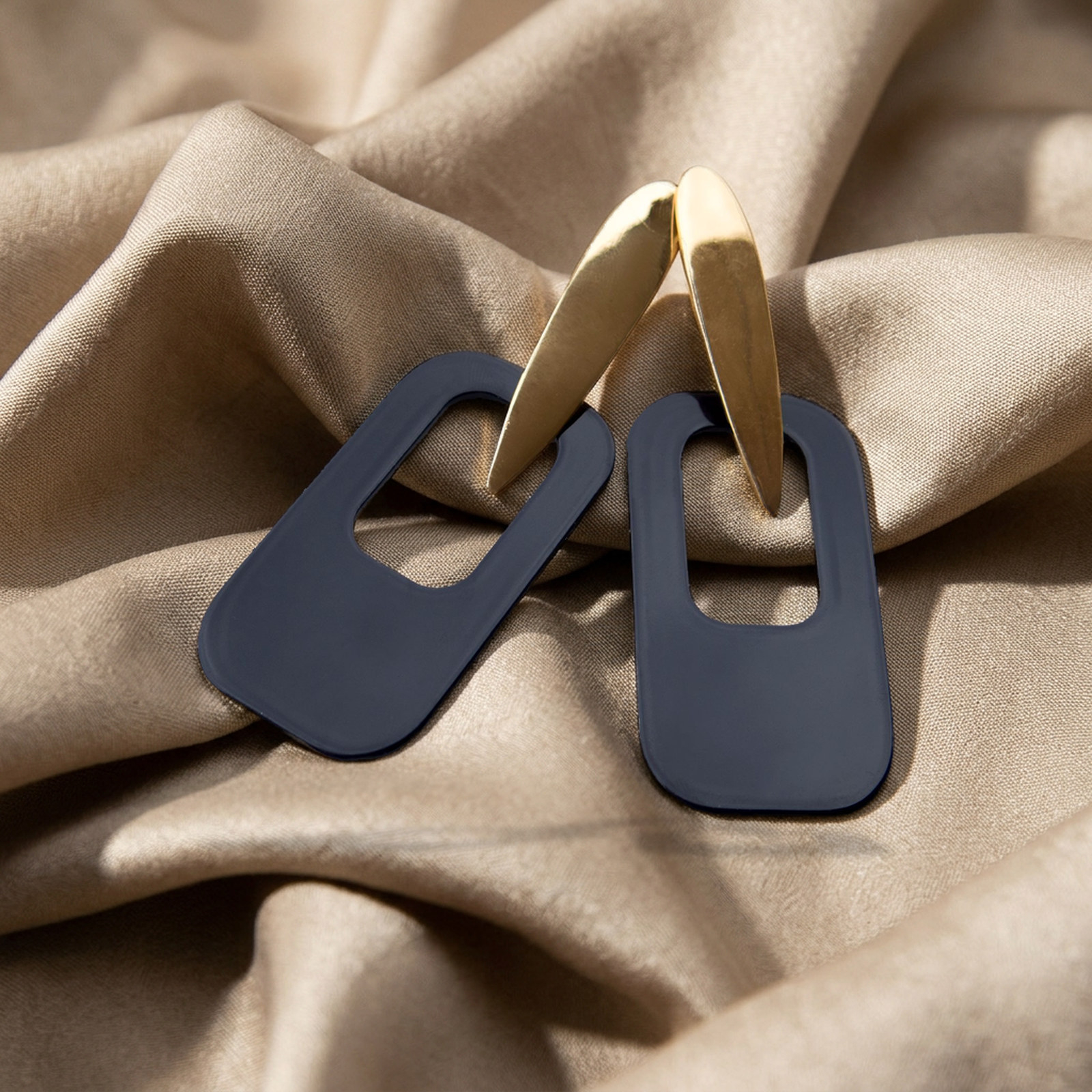 after: AI photoshoot of jewelry in beige silk
