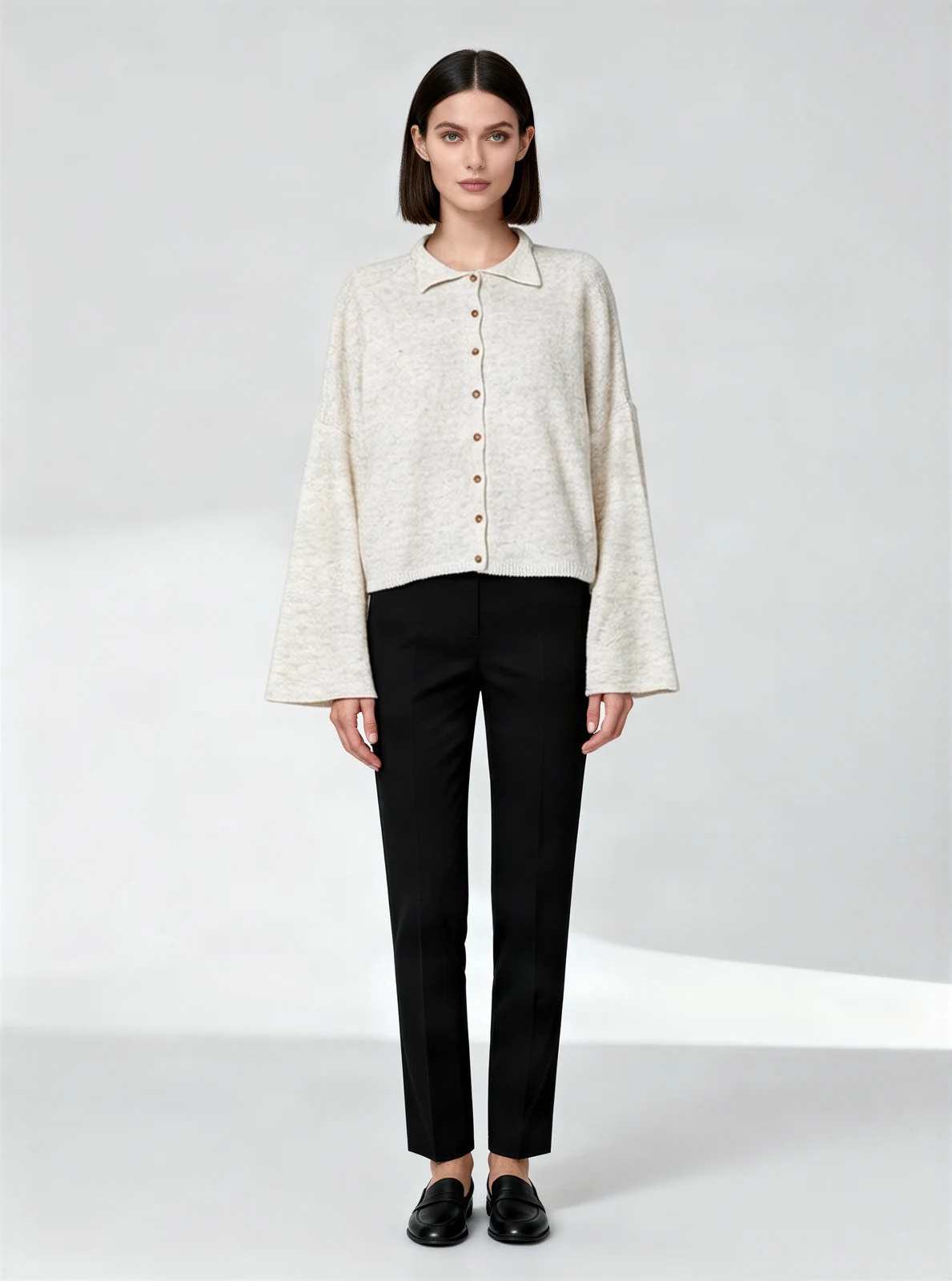 AI fashion model wearing the cream cardigan, standing in a light studio - AI-generated model