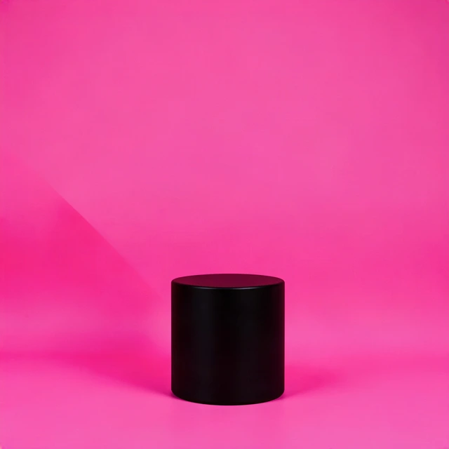 Black cylinder plinth on a hot-pink paper sweep, a Black Friday product backdrop