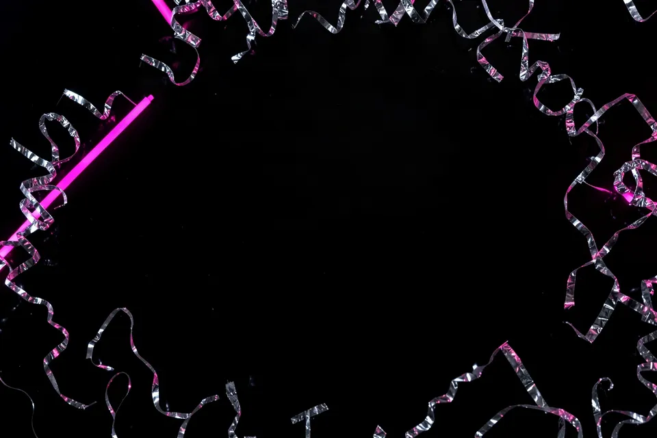 Silver confetti framing empty black space for a Black Friday sale headline