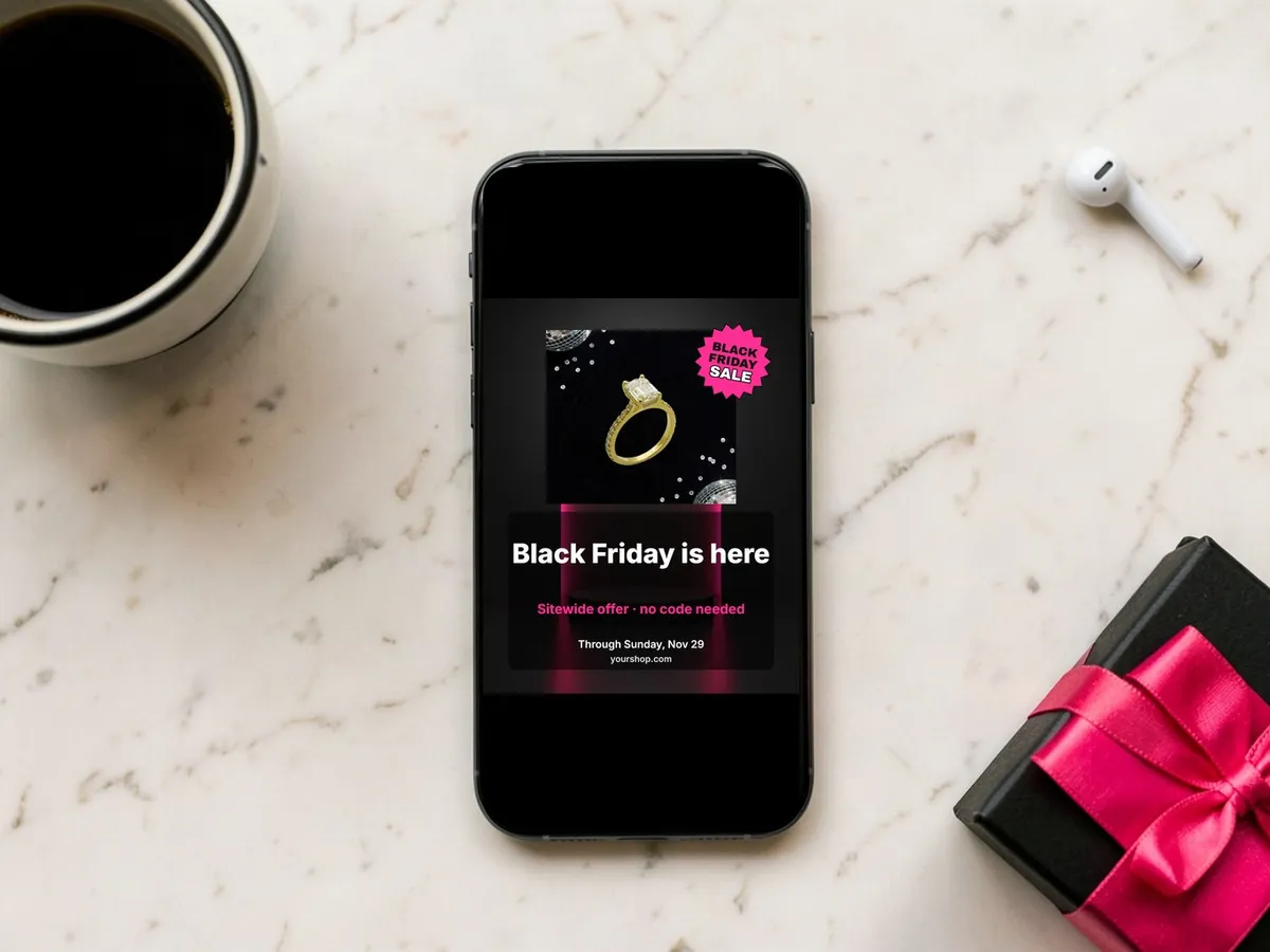 Phone on marble showing a 4:5 Black Friday sale post beside coffee and a gift