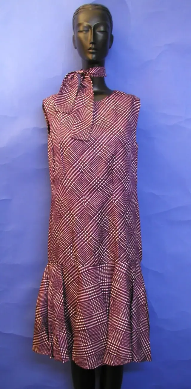 One piece on a mannequin, dress form or hanger, front-facing, fully in frame.
