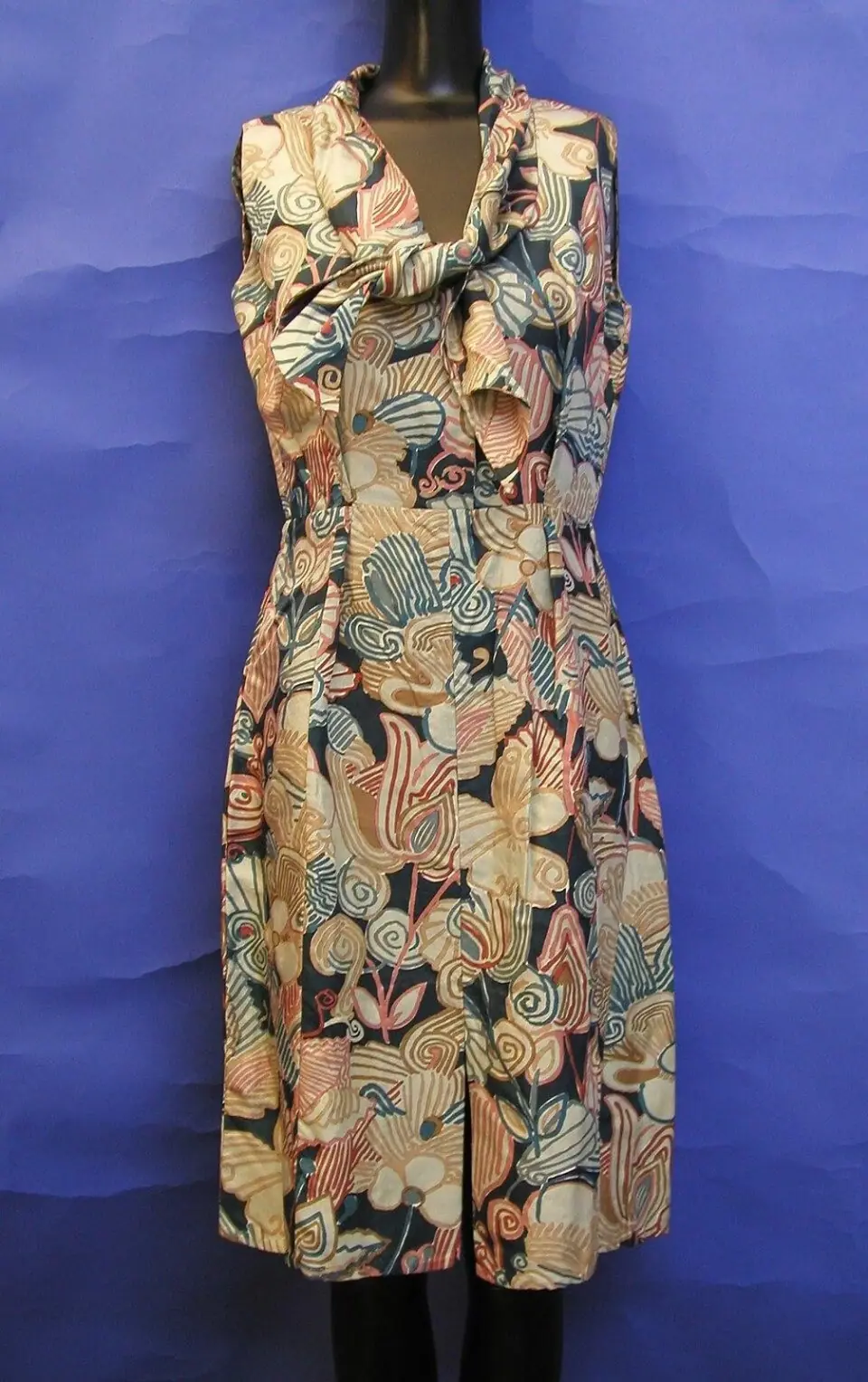 One piece on a mannequin, dress form or hanger, front-facing, fully in frame.