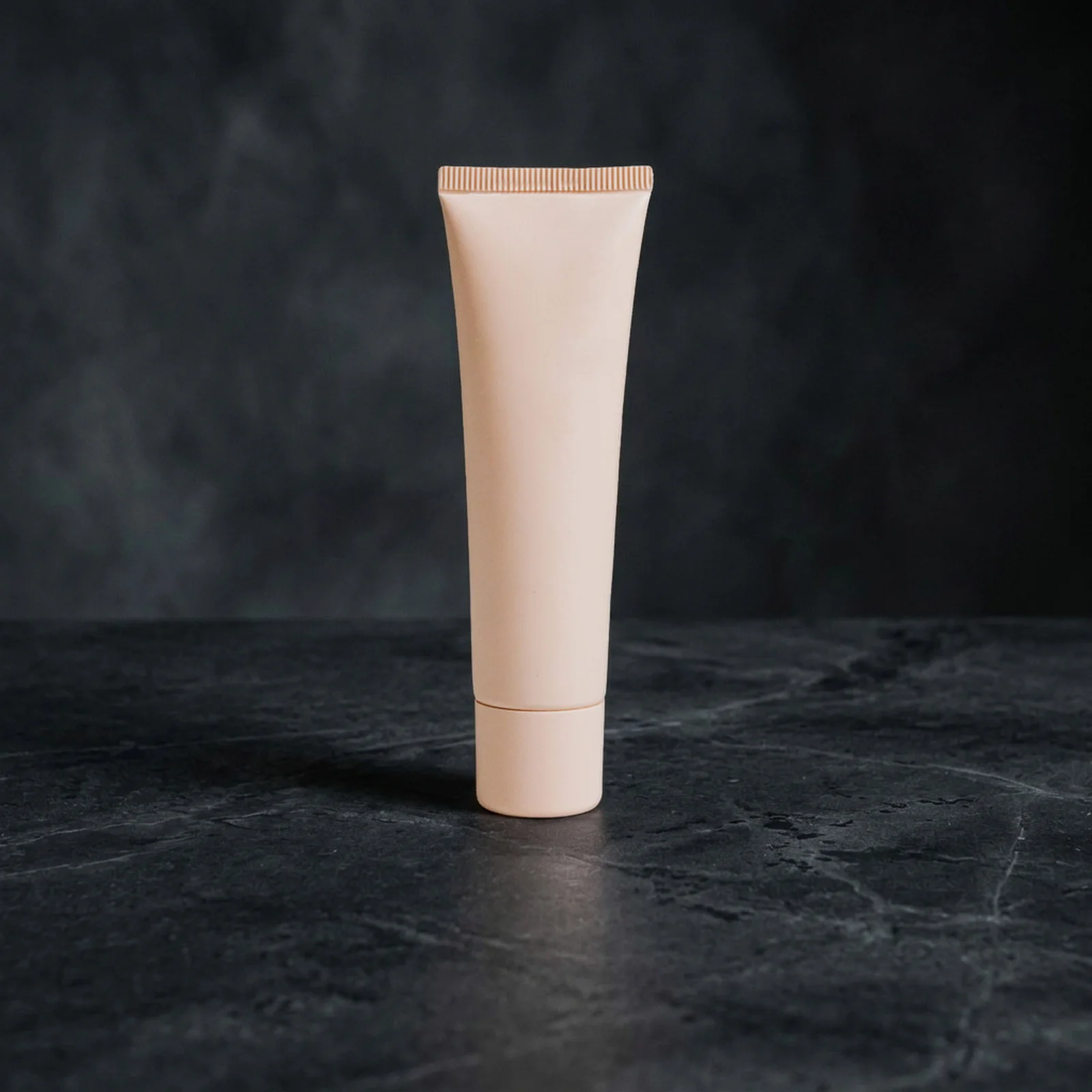 after: the same unbranded skincare tube on dark stone