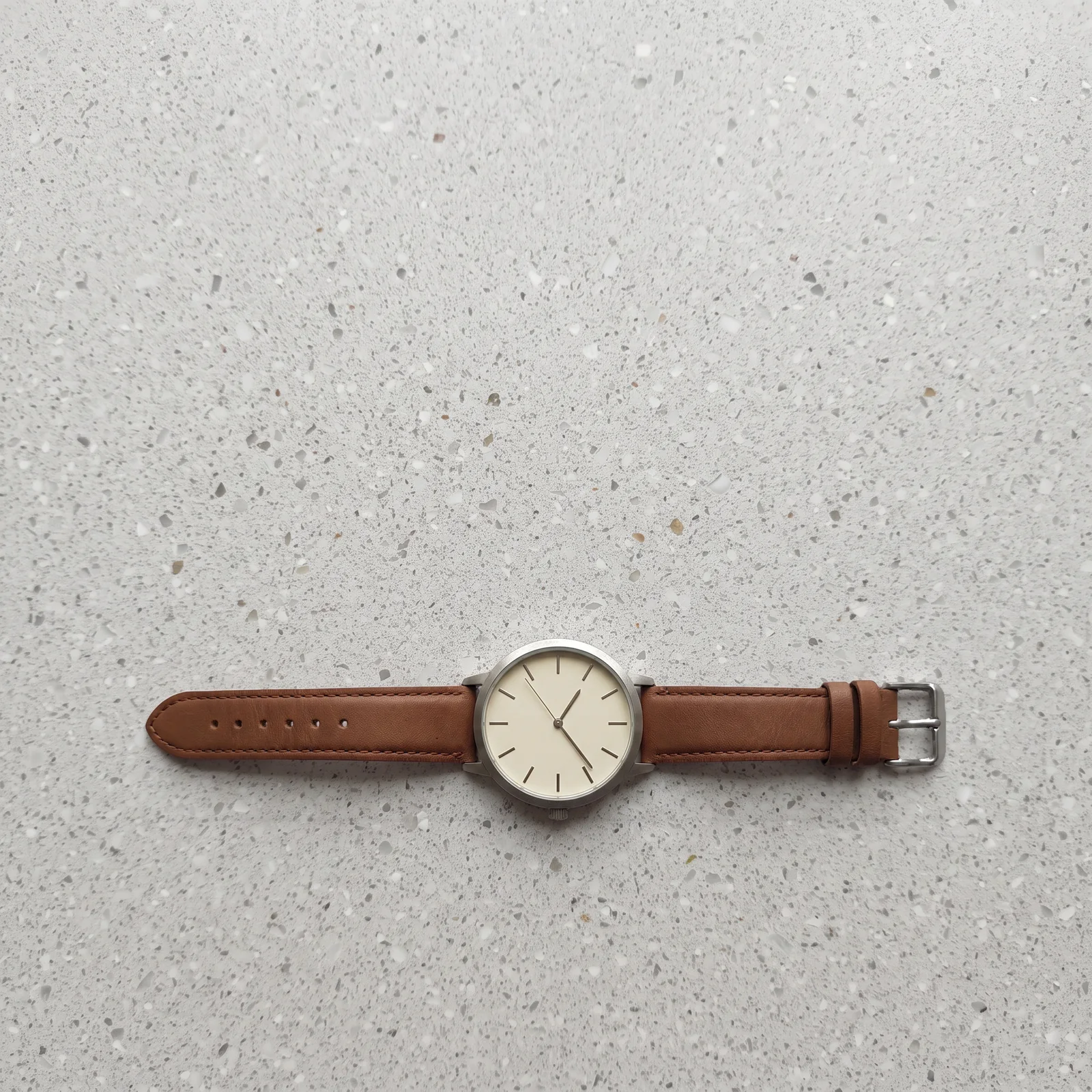 unbranded watch on light terrazzo