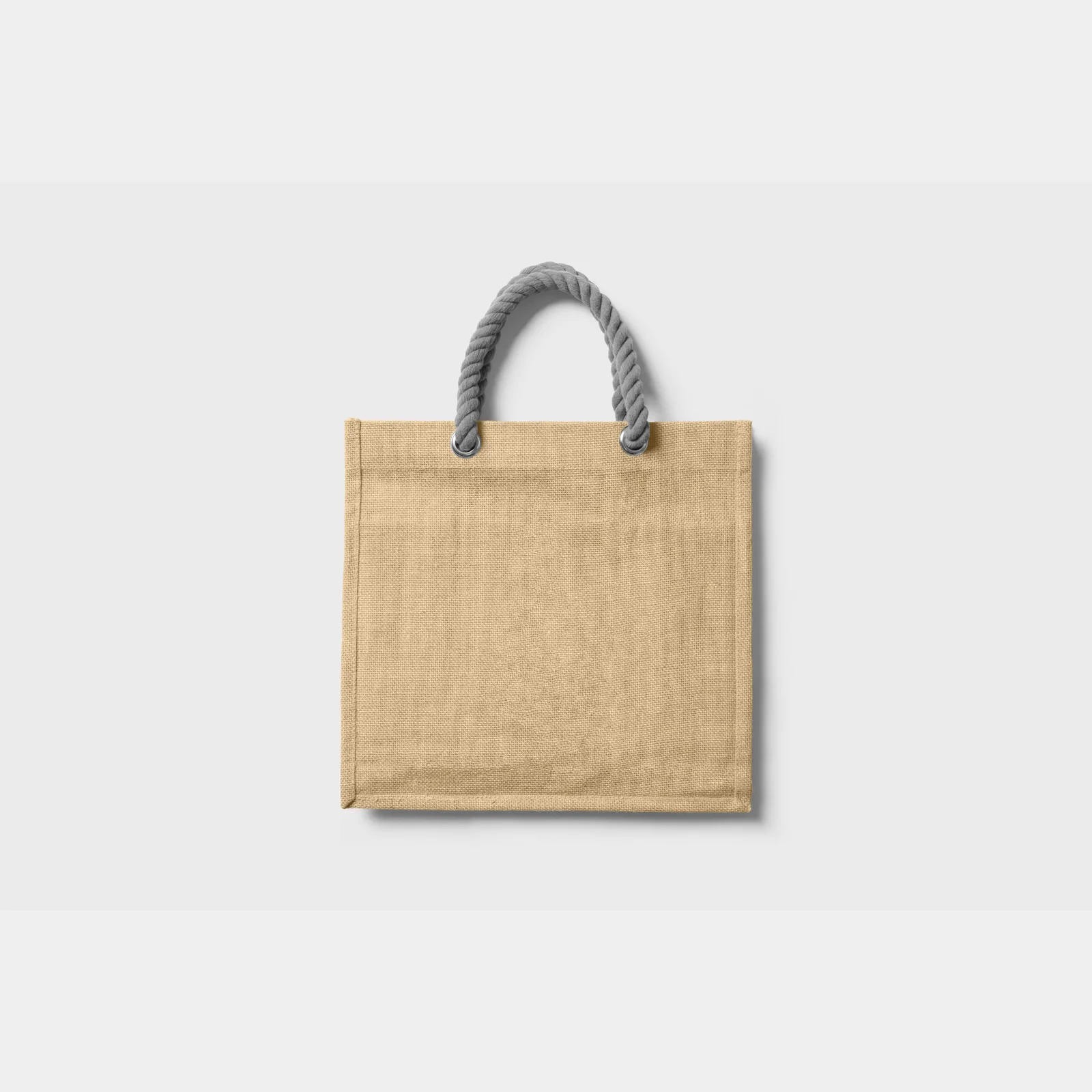 Jute tote with gray rope handles photographed against a pale gray background