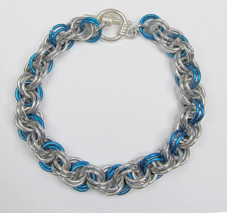 before: silver and blue bracelet on a grey display