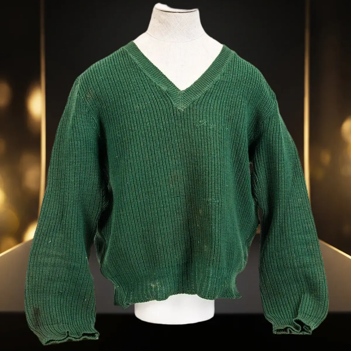 Knit sweater on a dress form in a black and gold Black Friday scene