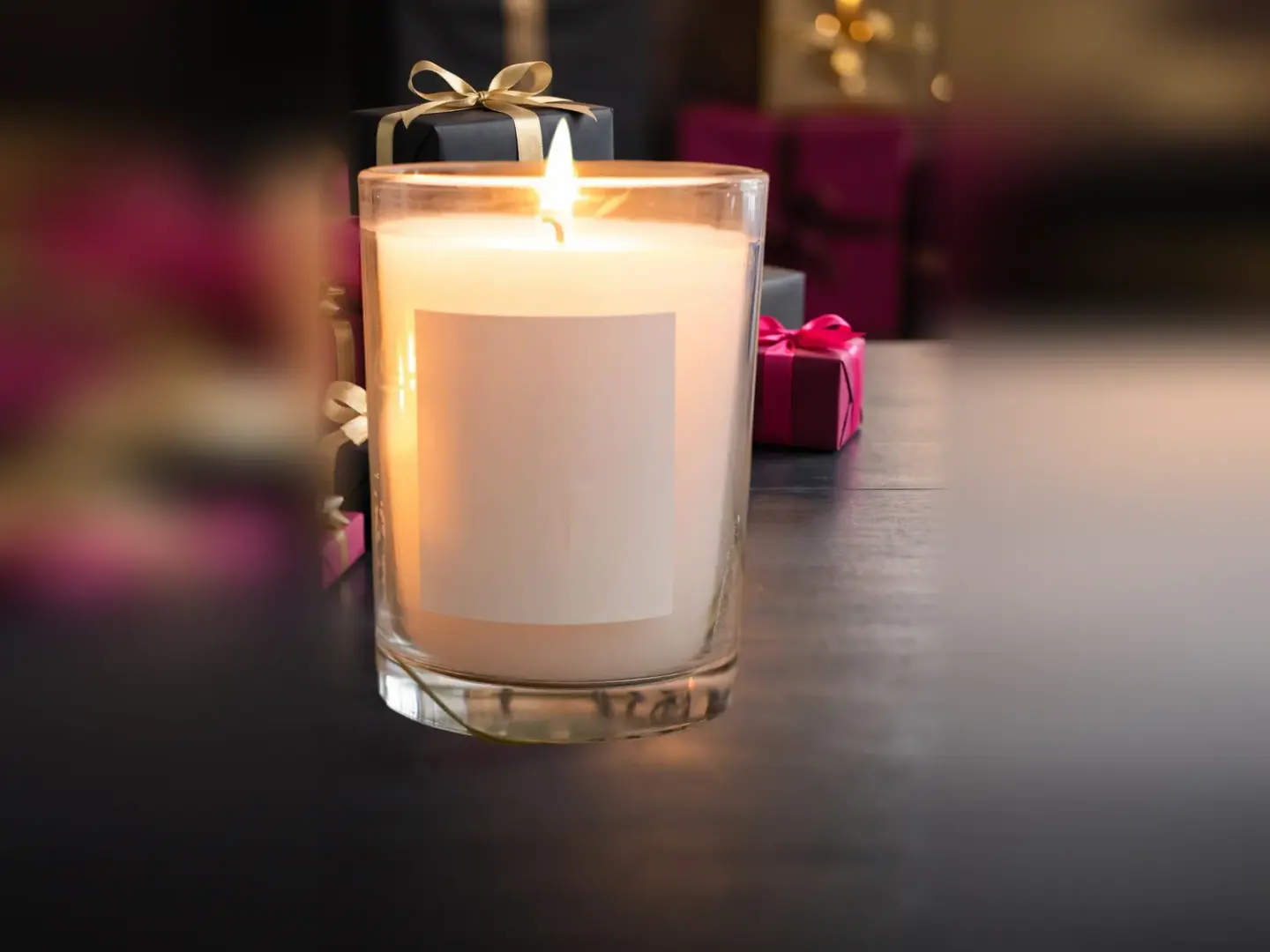 Soy candle in front of pink gift boxes in a Black Friday scene