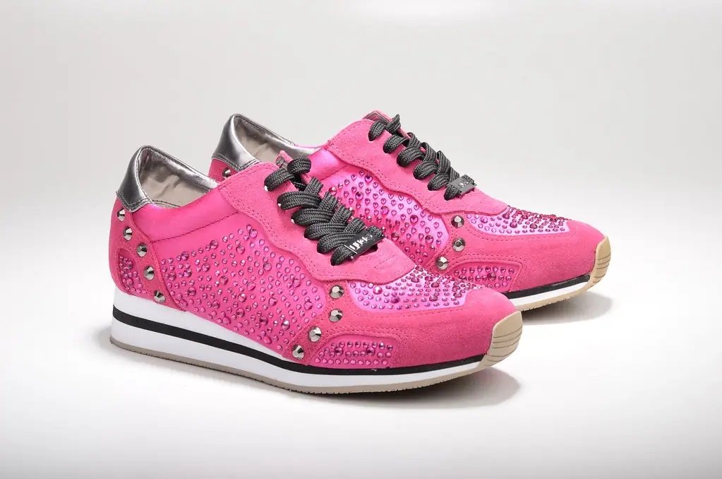 before: paired pink shoes with decorated uppers photographed on a pale background