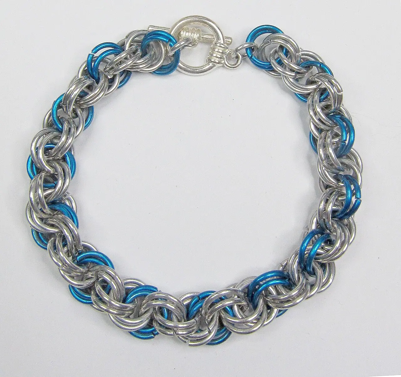 before: silver chain bracelet with blue accents in the original photo