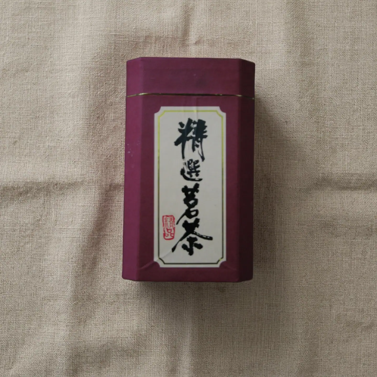 after: AI photoshoot of a tea tin with printed text
