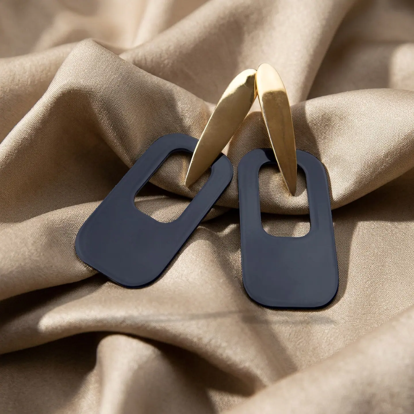 after: AI photoshoot of jewelry in beige silk